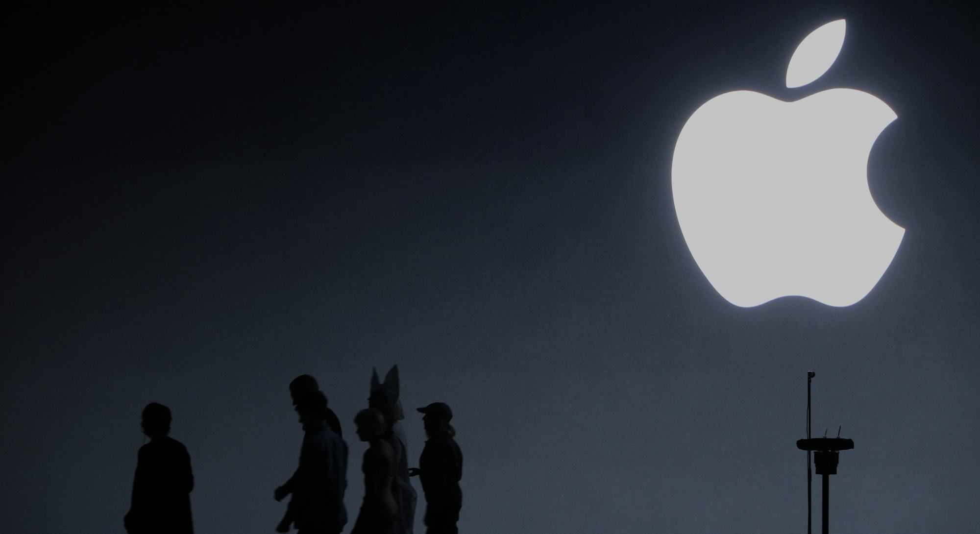 Apple CEO Tim Cook, singer Sia, and dancer Maddie Ziegler leave the stage following an Apple Event t...