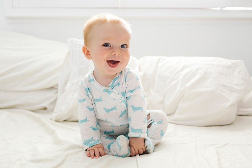 cute baby boy on a bed in an article about boy names that start with C