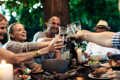 Happy family having a garden party in an article round up of Instagram captions about wine