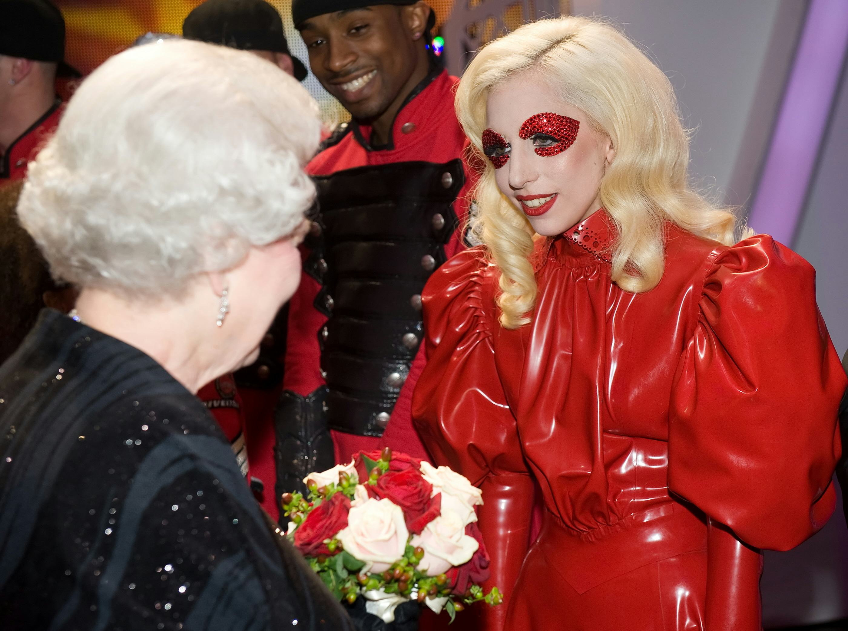 12 Photos Of Celebs Meeting Queen Elizabeth II: Marilyn Monroe, Lady Gaga, J.Lo, & More