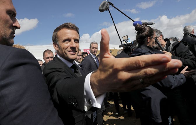 French President Emmanuel Macron greets attendees during a meeting with young farmers in Outarville