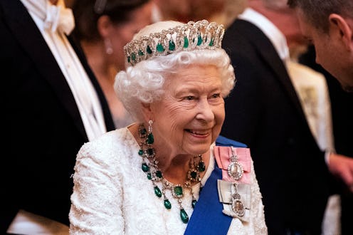 L0NDON, ENGLAND - DECEMBER 11: Queen Elizabeth II talks to guests at an evening reception for member...