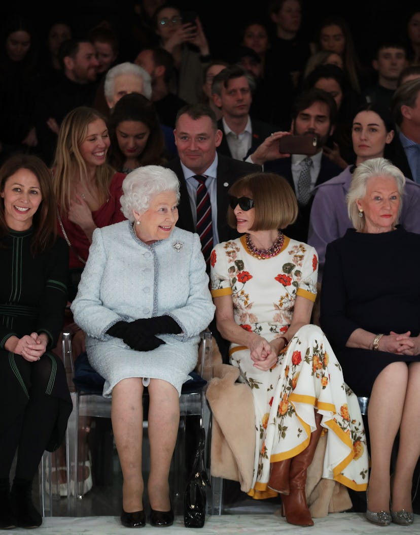 Queen Elizabeth II sits next to Anna Wintour (right) as they view Richard Quinn's runway show