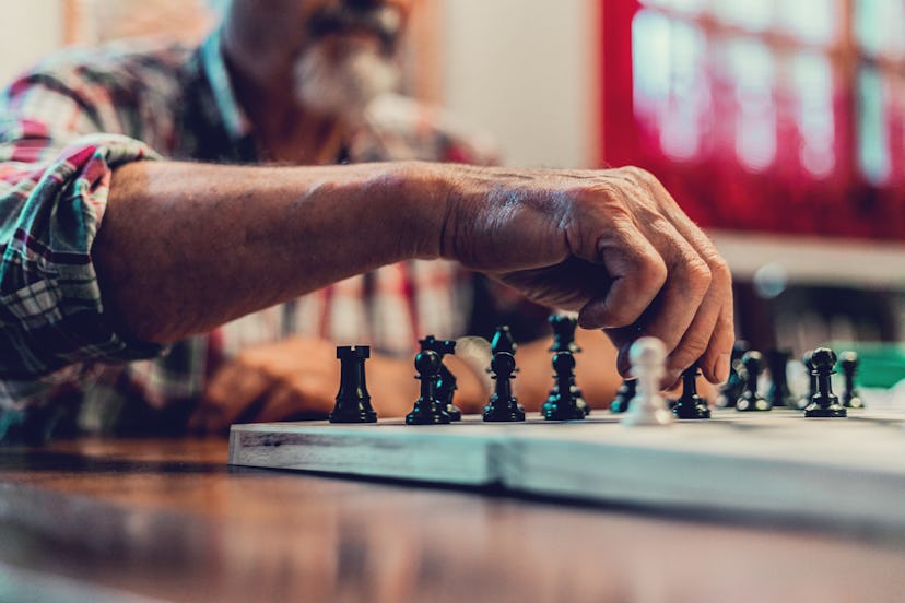 closeup hands of senior man playing  chess, how to recognize a toxic grandparent