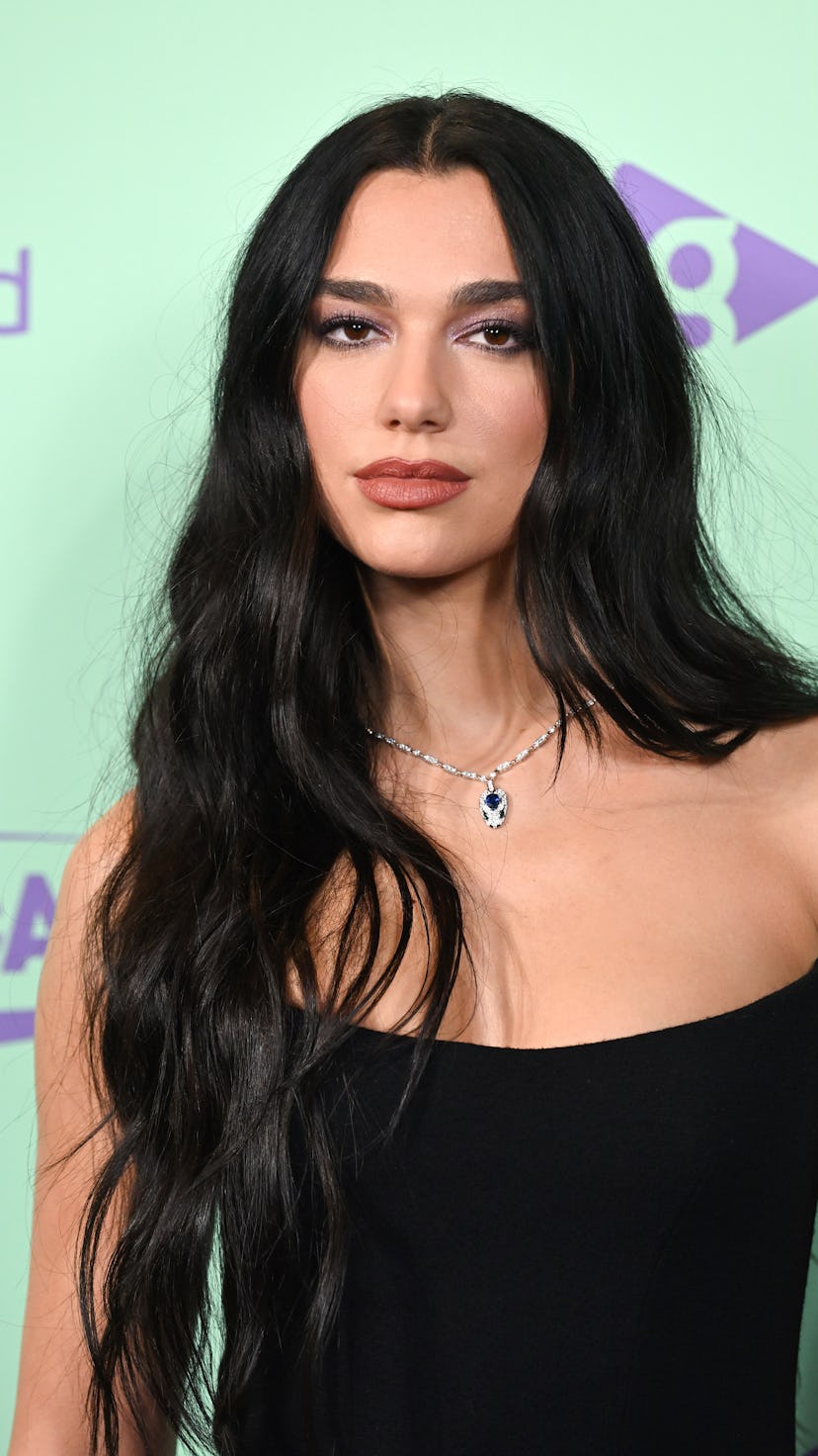 Dua Lipa with long black wavy hair at the Capital Jingle Bell Ball 2022.