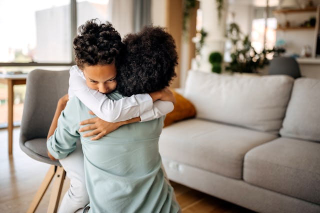 Mother and son hugging at home