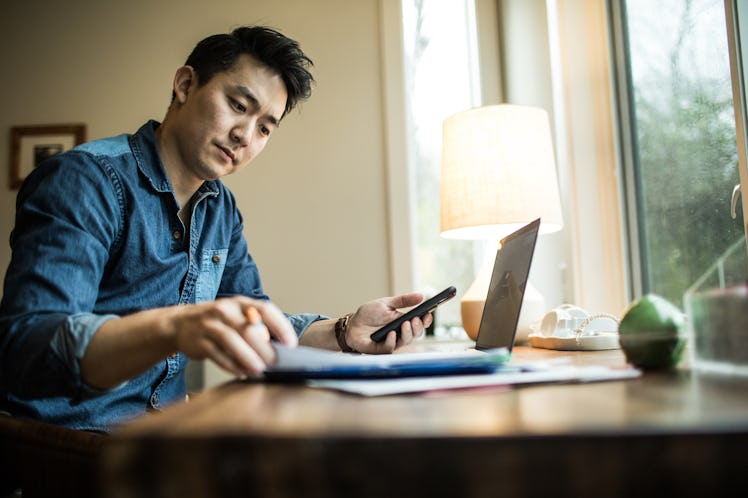 Man (early 30s) working in home office.