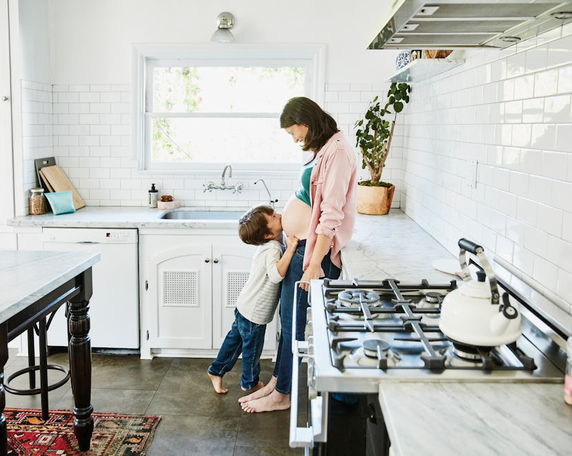 a mom and child in the kitchen with a gas stove. but are gas stoves dangerous do they cause asthma?