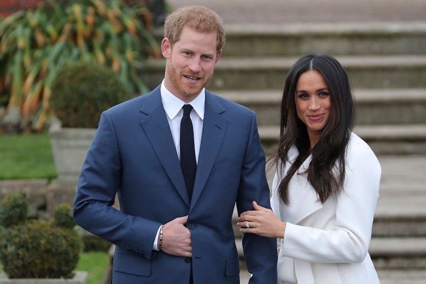 Britain’s Prince Harry stands with his fiancée US actress Meghan Markle as she shows off her engagem…