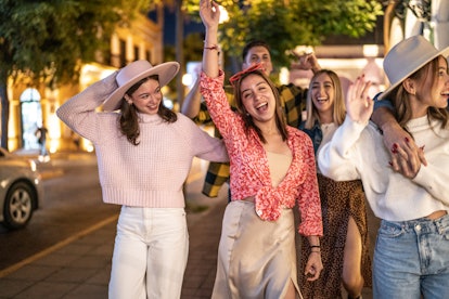 Gen Z friends explore a city by foot, which is one of the best TikTok travel tips for free activitie...
