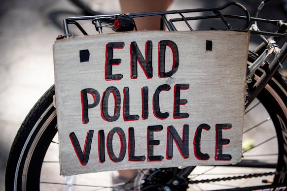 BROOKLYN, NY - July 25: A protester's bicycle has a sign attached to the back that says, "End Police...