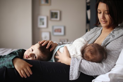 woman breastfeeding in an article about why do newborns cough while breastfeeding