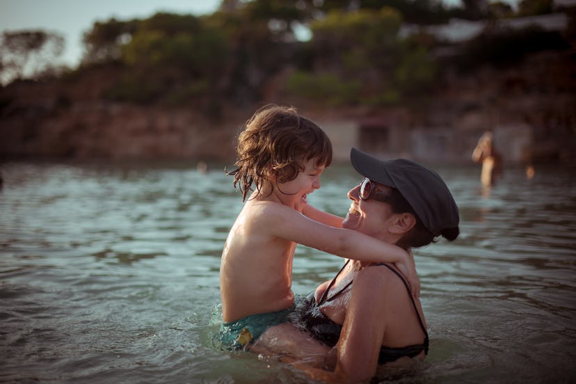 a mom and son playing in the water because your aquarius baby is a water sign