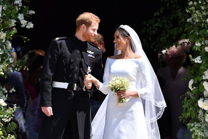 TOPSHOT - Britain's Prince Harry, Duke of Sussex and his wife Meghan, Duchess of Sussex emerge from ...