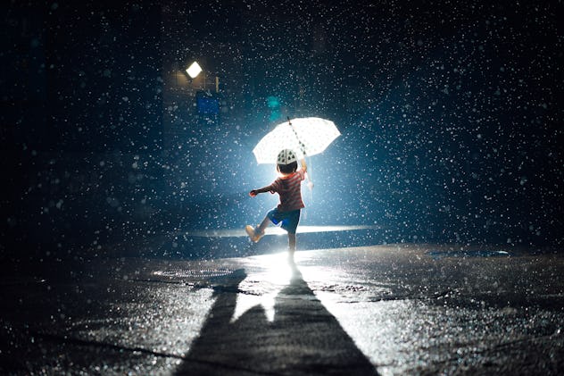 an aquarius child dancing in the rain