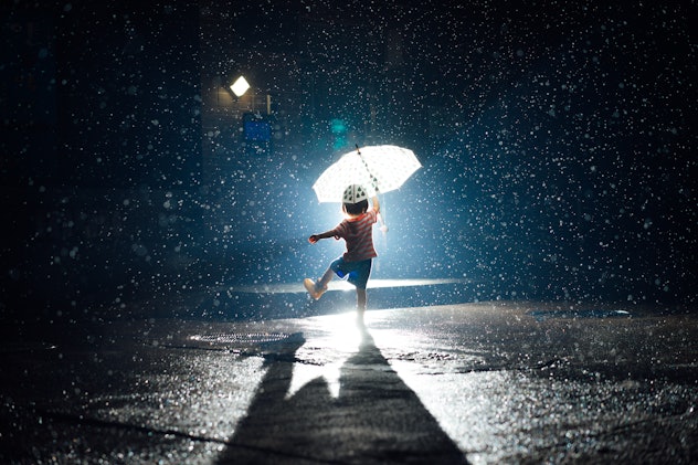 an aquarius child dancing in the rain