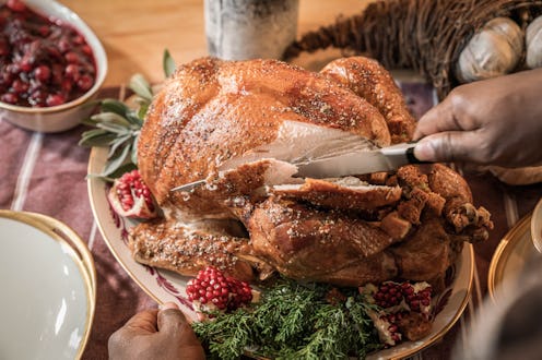A Black family gathers together to cook and eat a Thanksgiving meal.
