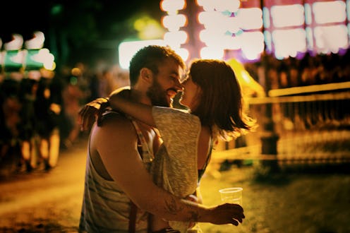 Young couple enjoying at music festival.