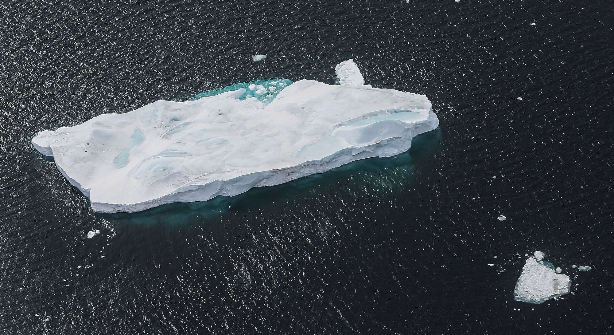 ANTARCTICA - OCTOBER 27:  An iceberg floats near the coast of West Antarctica as seen from a window ...