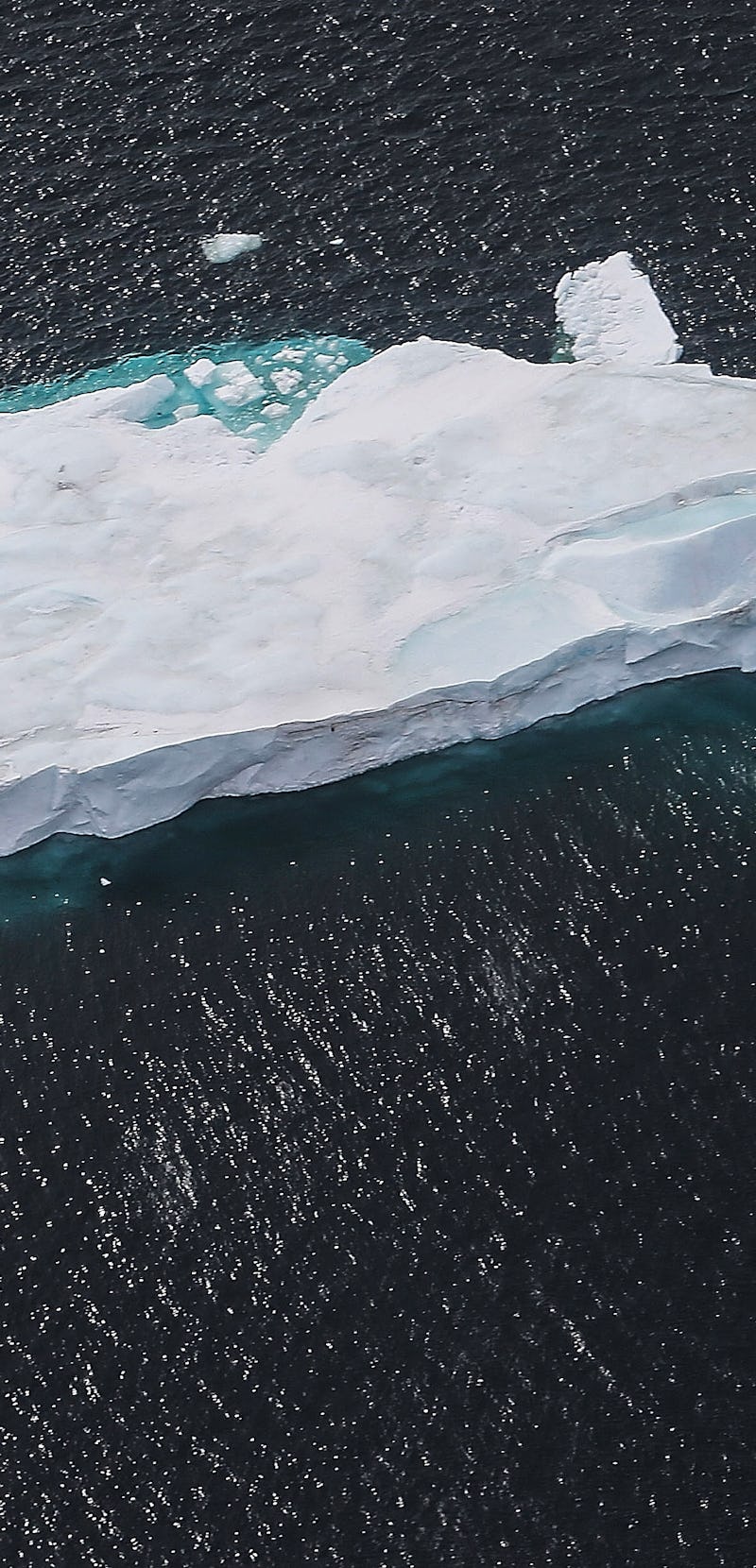 ANTARCTICA - OCTOBER 27:  An iceberg floats near the coast of West Antarctica as seen from a window ...