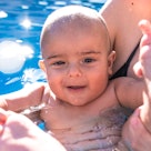Portrait of a baby bathing in a swimming pool.