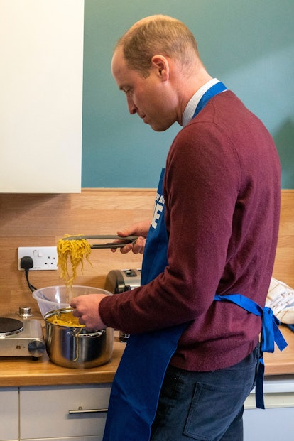 Britain's Prince William, Prince of Wales takes part in a cooking lesson.