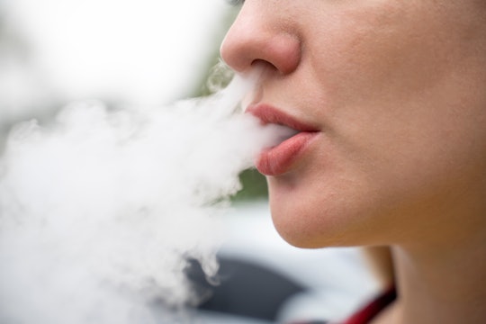 Closeup of woman vaping in an article about secondhand smoke bad for pregnancy