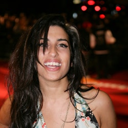 Amy Winehouse poses on the red carpet during The 25th BRIT Awards 2005