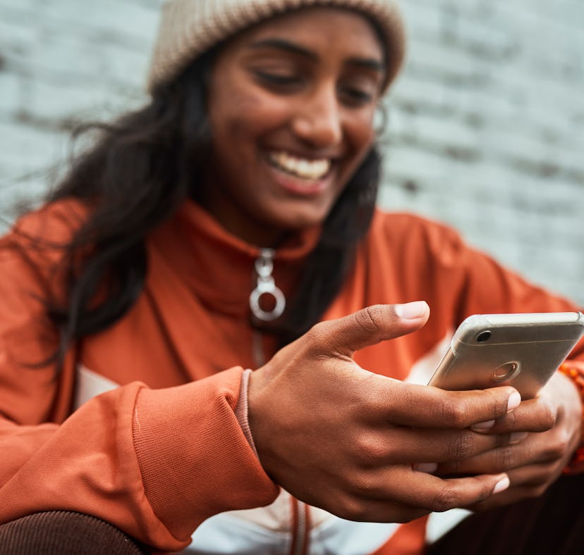 A woman looks at the "oops got your" trend on TikTok with people outing themselves.