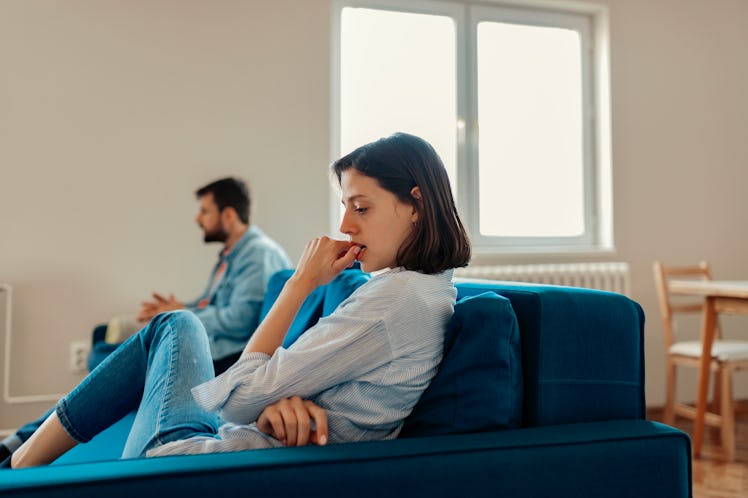Unhappy Couple After an Argument in the Living Room at Home. Sad Pensive Young Girl Thinking of Rela...