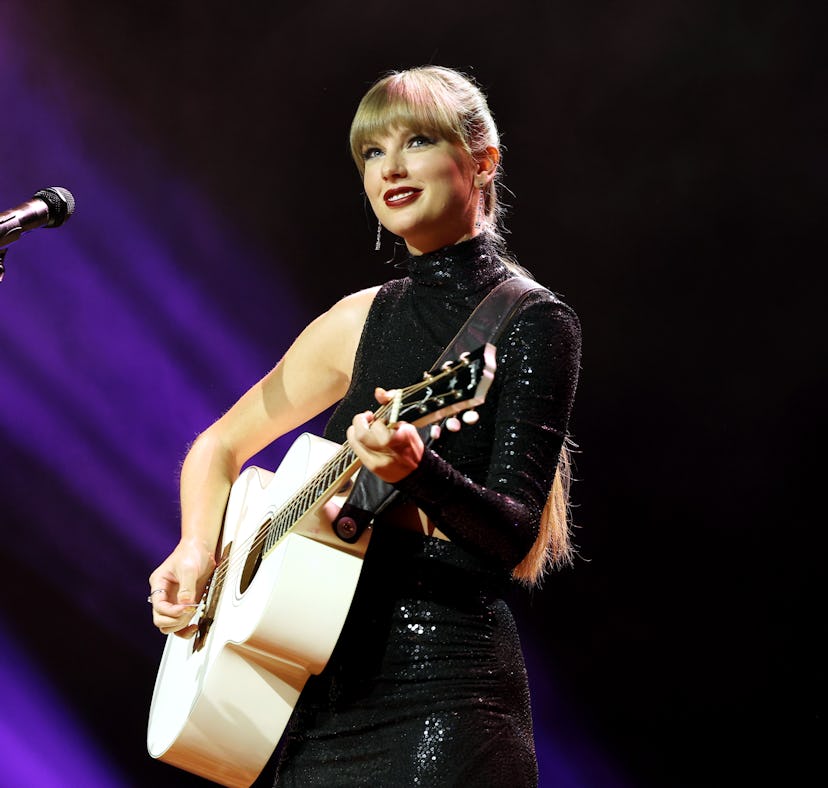 Taylor Swift performs with a guitar and you can win a signed Taylor Swift guitar and other items in ...