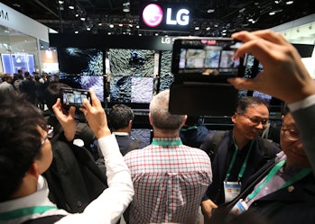 LAS VEGAS, NEVADA - JANUARY 07: People take photos of the LG Signature OLED R rollable televisions a...