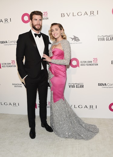 Liam Hemsworth and singer Miley Cyrus arrive at the 26th Annual Elton John AIDS Foundation's Academy...