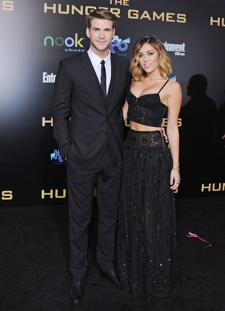 Liam Hemsworth and singer Miley Cyrus arrive at the Los Angeles Premiere "The Hunger Games" 