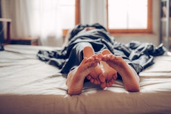 Adult couple's feet looking out of bed, vagina itchy after sex