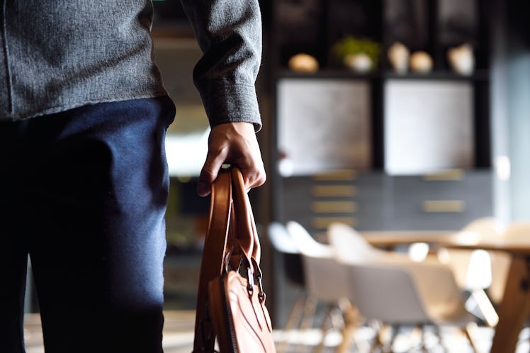 a man holding a briefcase as he goes home from work