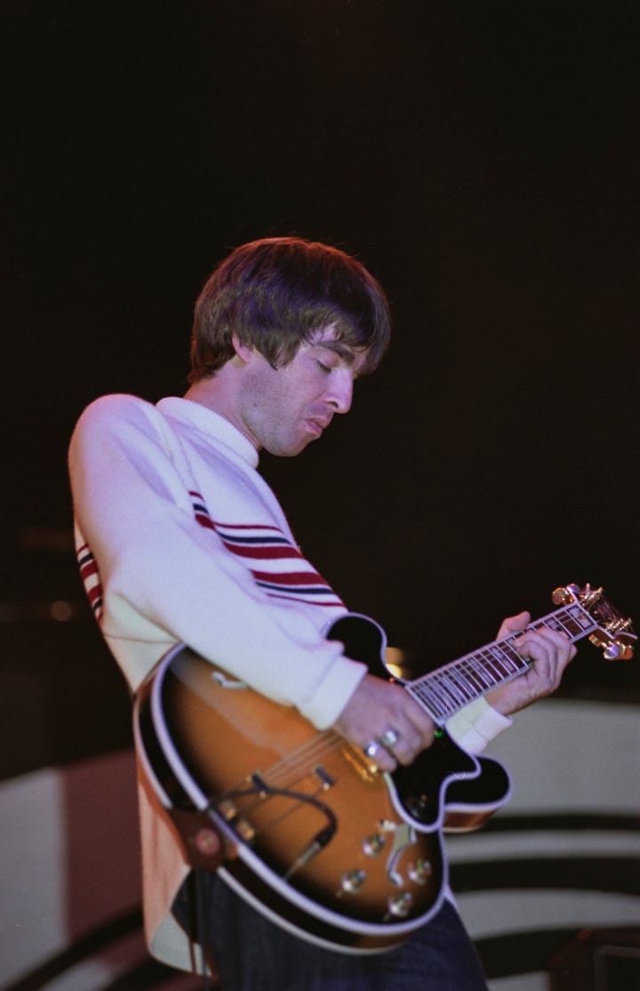 Guitarist and songwriter, Noel Gallagher, performing with British rock group, Oasis, at Knebworth Ho...