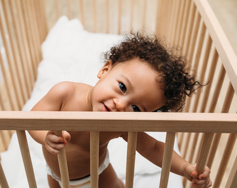a cute toddler in crib, toddler keeps taking diaper off at night