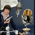 The Jet Propulsion Lab's Donna Pivirotto stands with a collection of models of NASA space probes, in...