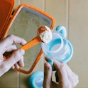 Hand scooping baby food. The FDA released new guidance limiting the amount of lead allowed in proces...