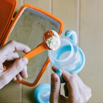 Hand scooping baby food. The FDA released new guidance limiting the amount of lead allowed in proces...
