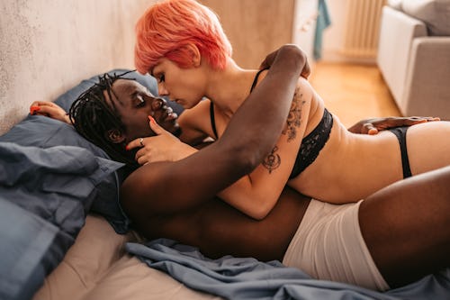 couple in bed learning how to talk about sex with your partner