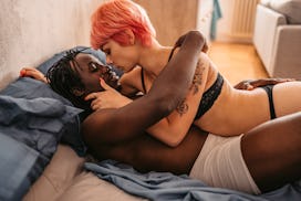 couple in bed learning how to talk about sex with your partner