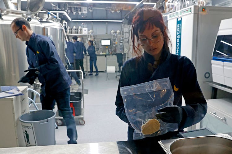 A technician holds a lab-grown chicken meat in a sealed bag at the food-tech startup SuperMeat in th...