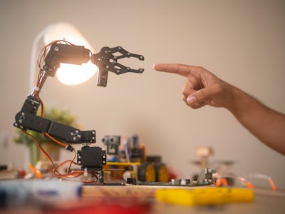 Robot hand touching with human hand