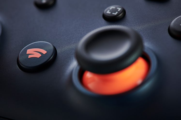 Close-up detail of the Home button on a Google Stadia video game controller with a Night Blue finish...