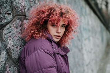 A young woman with curly pink hair stares into the camera, as she considers her January 30, 2023 wee...
