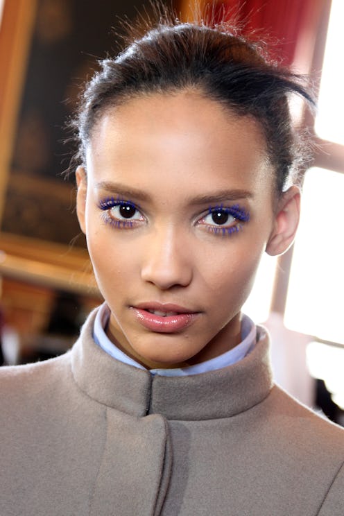 Colored mascara is a quick way to elevate a natural makeup look. Here, a model backstage at Stella M...