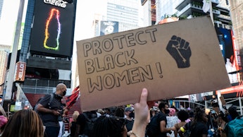 MANHATTAN, NY - July 26: A protester holds a handmade sign that says "Protect Black Women!" with the...
