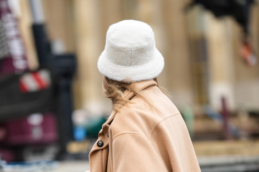 PARIS, FRANCE - JANUARY 24: A guest wears a white fluffy bob, a beige wool jacket, outside Stephane ...